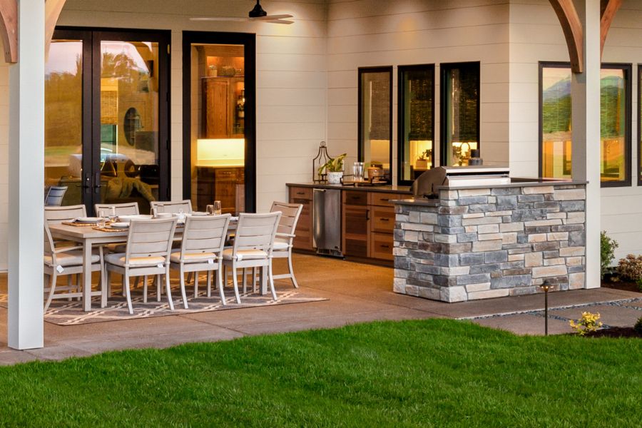 outdoor hardscaping features including patio pavers and outdoor kitchen
