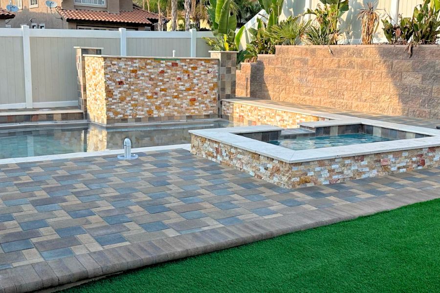 Designing the perfect pool deck with materials like concrete and pavers, featuring a stylish backyard pool